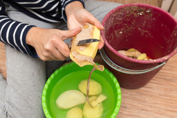 woman peeling potatoes