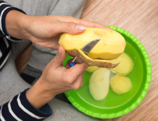 woman peeling potatoes
