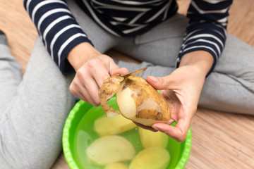 woman peeling potatoes