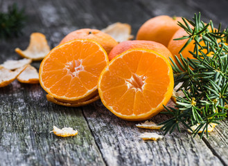 Ripe Mandarin fruit peeled open and place on old rustic look tim