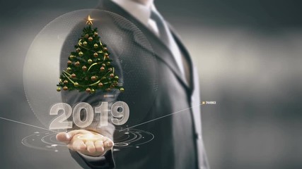 2019 Christmas tree Businessman Holding in Hand New technologies - Powered by Adobe