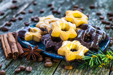 Plate with tasty Christmas cookies on wooden table