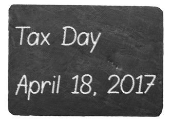 Tax Day concept using chalk on slate blackboard