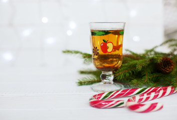 Wooden background. Hot tea. Sweets. The concept of Christmas 
