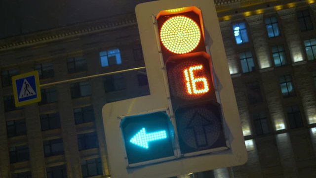 Traffic lights regulate the movement of vehicles. At night in the winter.