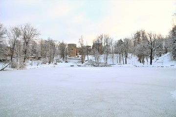 Winter park with old castle ruins in Cesis town, Latvia