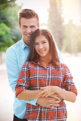 Obraz premium Beautiful young couple outdoors on blurred background