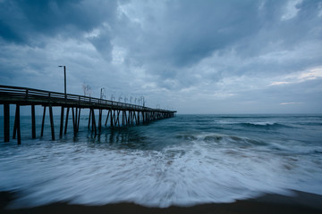 Waves in the Atlantic Ocean and the fishing pier in Virginia Bea