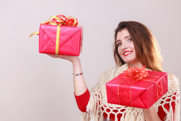 Woman holds red christmas gift boxes