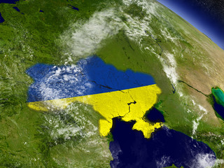 Ukraine with embedded flag on Earth