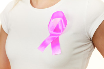 Closeup pink cancer ribbon on woman chest