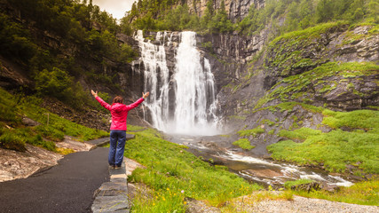 Tourist woman by Skjervsfossen Waterfall - Norway