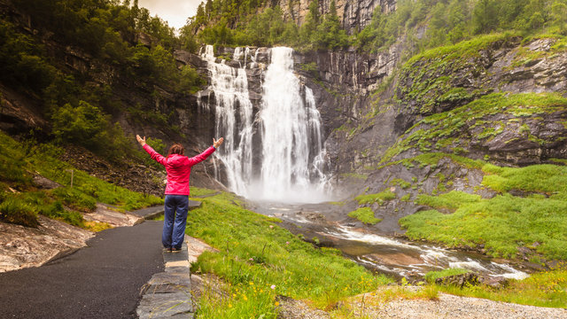 Tourist woman by Skjervsfossen Waterfall - Norway