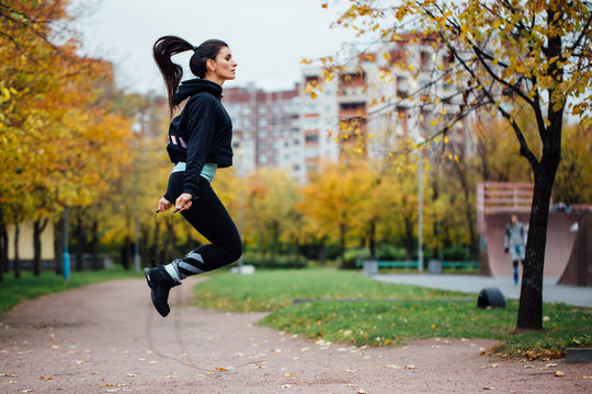 Woman Feet Jumping, Using Skipping Rope In Park.