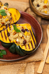 Roasted Pumpkin Stuffed with Quinoa, Nuts and Dried Fruit. Selective focus.