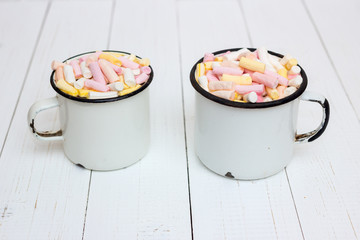 Two cups of hot cocoa with color marshmallow