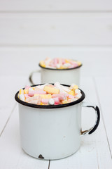 Two cups of hot cocoa with color marshmallow