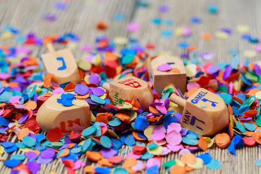 wooden dreidels spinning top for hanukkah jewish holiday over glitter gold background - Powered by Adobe