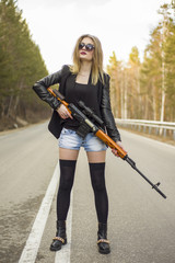 Girl assassin waiting for his victim on the road.