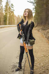 Girl assassin waiting for his victim on the road.