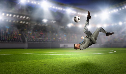 Fototapeta na wymiar Businessman playing soccer . Mixed media
