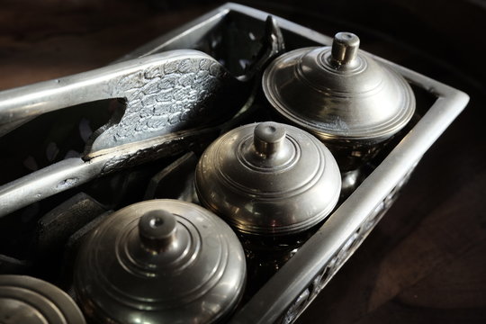 Malay heritage brassware, wedding equipment called Tepak Sireh over wooden background. shoot in low light and selective focus