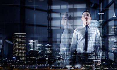 Fototapeta premium Businessman in modern office. Mixed media . Mixed media