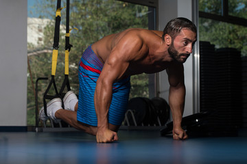 Man Exercising Push Ups With Trx Fitness Straps