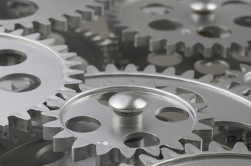 Silver Gears Working Together And Interlocked