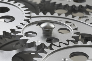 Silver Gears Working Together And Interlocked
