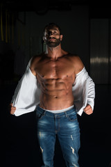 Obraz na płótnie Canvas Sexy Latin Man Posing In White Shirt