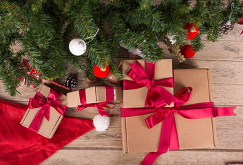 Brown gift box and christmas tree on wooden background