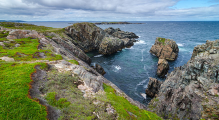 Cape Bonavista featuring coastal slabs of stone boulders and rocks that show their layers of formation over millions of years.  Rocky boulder shoreline in Newfoundland, Canada.