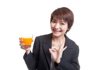 Young Asian woman show OK drink orange juice.