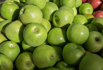 New green apples for sale at city market.