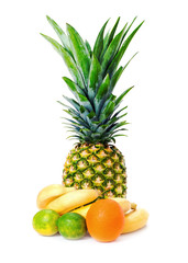 Ripe whole pineapple with ananas, bananas, limes and orange isolated on white background. Closeup.