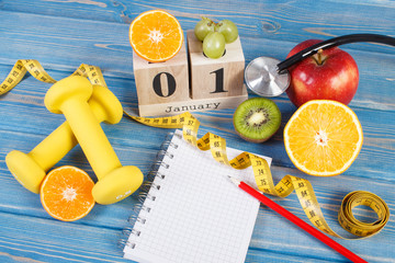 Cube calendar, fruits, dumbbells and tape measure, new years resolutions