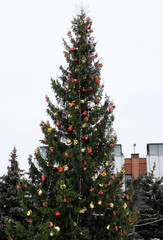 Christmas tree with garland and a star near the shopping center