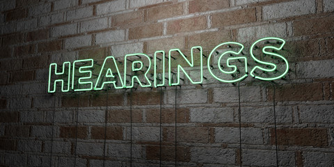 HEARINGS - Glowing Neon Sign on stonework wall - 3D rendered royalty free stock illustration.  Can be used for online banner ads and direct mailers..