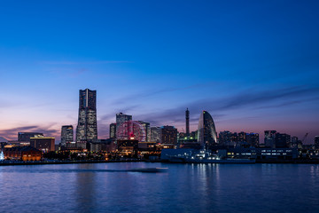 Naklejka na ściany i meble Yokohama Minato Mirai 21 seaside urban area in Japan at dusk