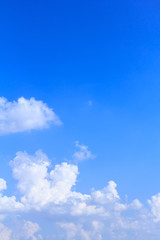 Blue sky background with white clouds and rain clouds. The vast blue sky and clouds sky on sunny day. White fluffy clouds in the blue sky.