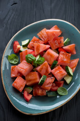 Grilled watermelon, tomato and cucumber salad, close-up