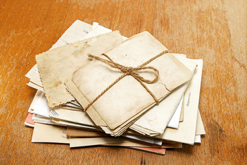 Old photographs, letters and papers on a desk / Russian translat