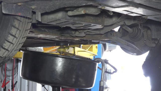 Used oil flow into car oil replacement equipment reservoir