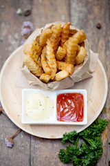 Tasty french fries on wooden table background,selective focus
