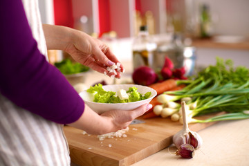 Young Woman Cooking in the kitchen. Healthy Food