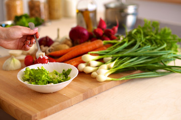 Young Woman Cooking in the kitchen. Healthy Food