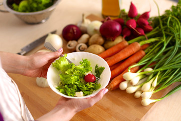 Young Woman Cooking in the kitchen. Healthy Food