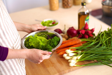 Young Woman Cooking in the kitchen. Healthy Food