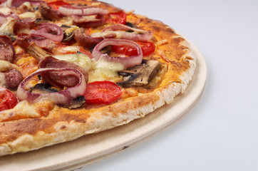 Delicious pizza with sausages and onion on light background